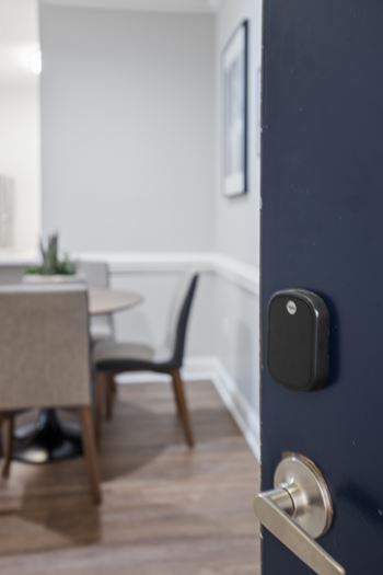 A dark blue door with a silver handle and a black lock.